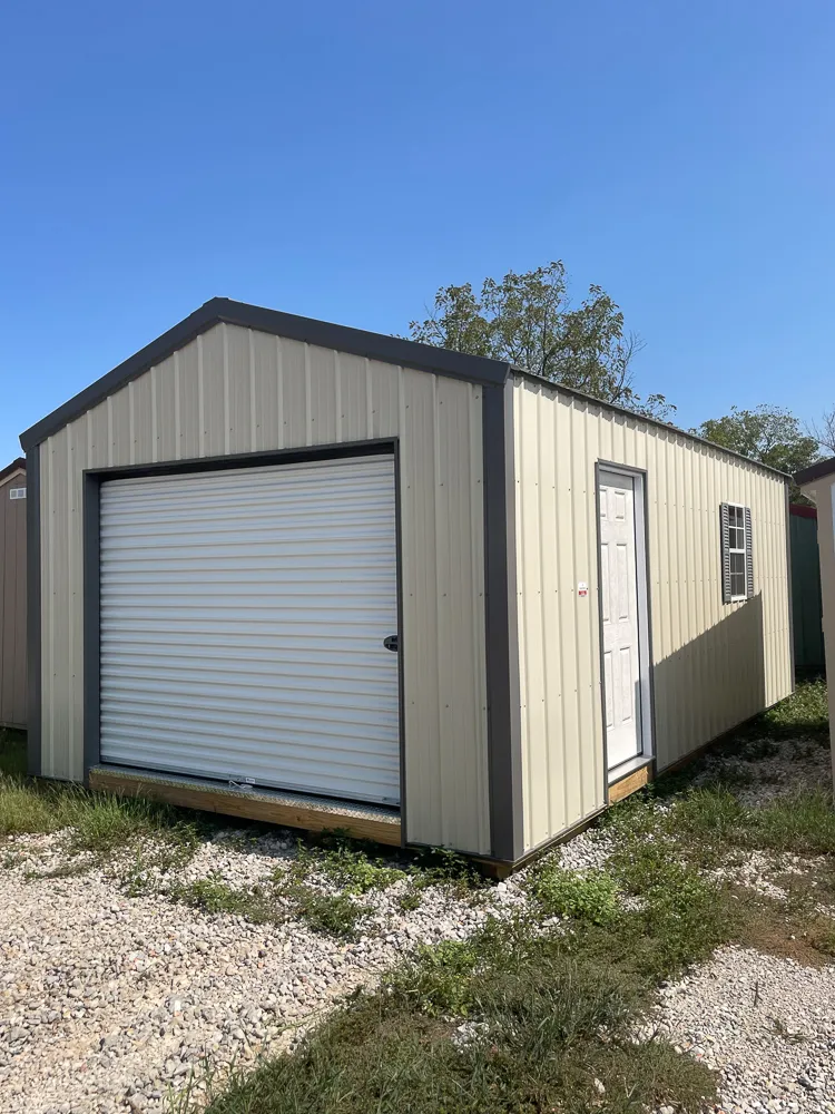 Gray and tan portable garage with a white roll-up door and a side entry door